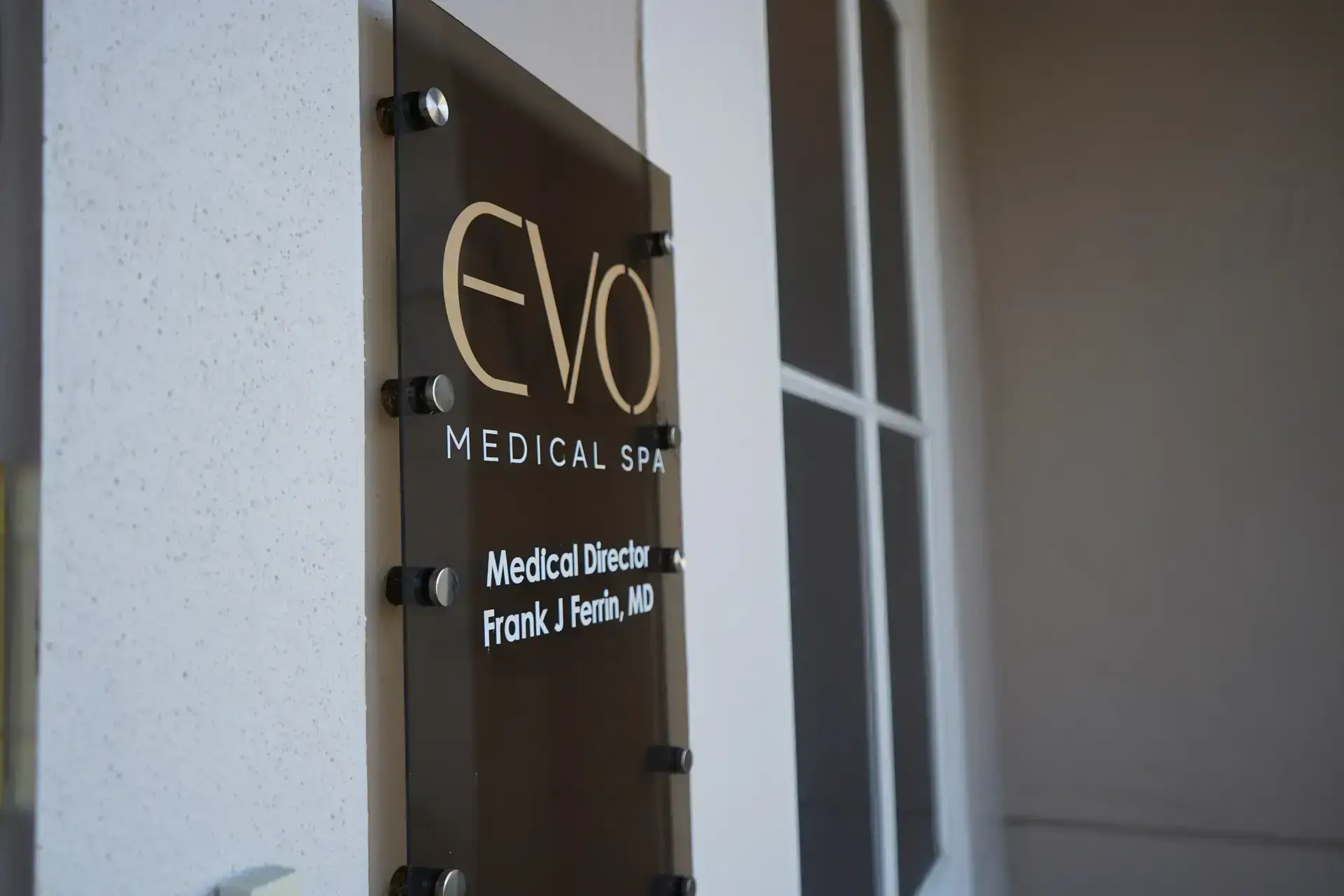 EVO Medical Spa entrance with the medical director’s name plate