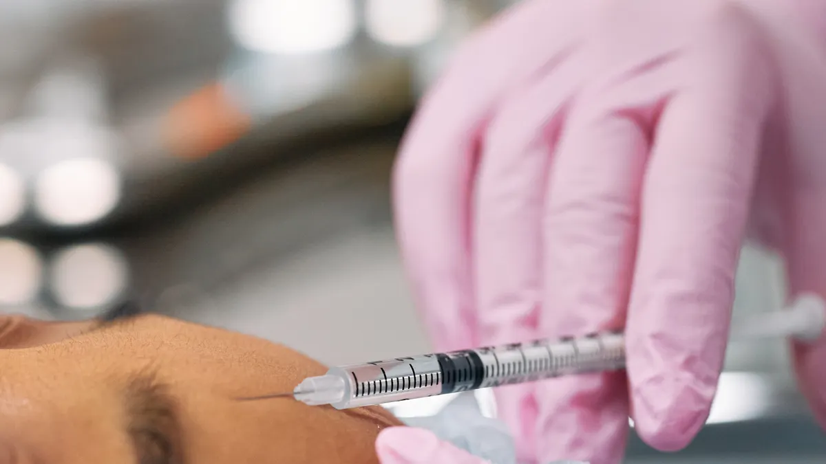 A licensed provider giving a neurotoxin injection