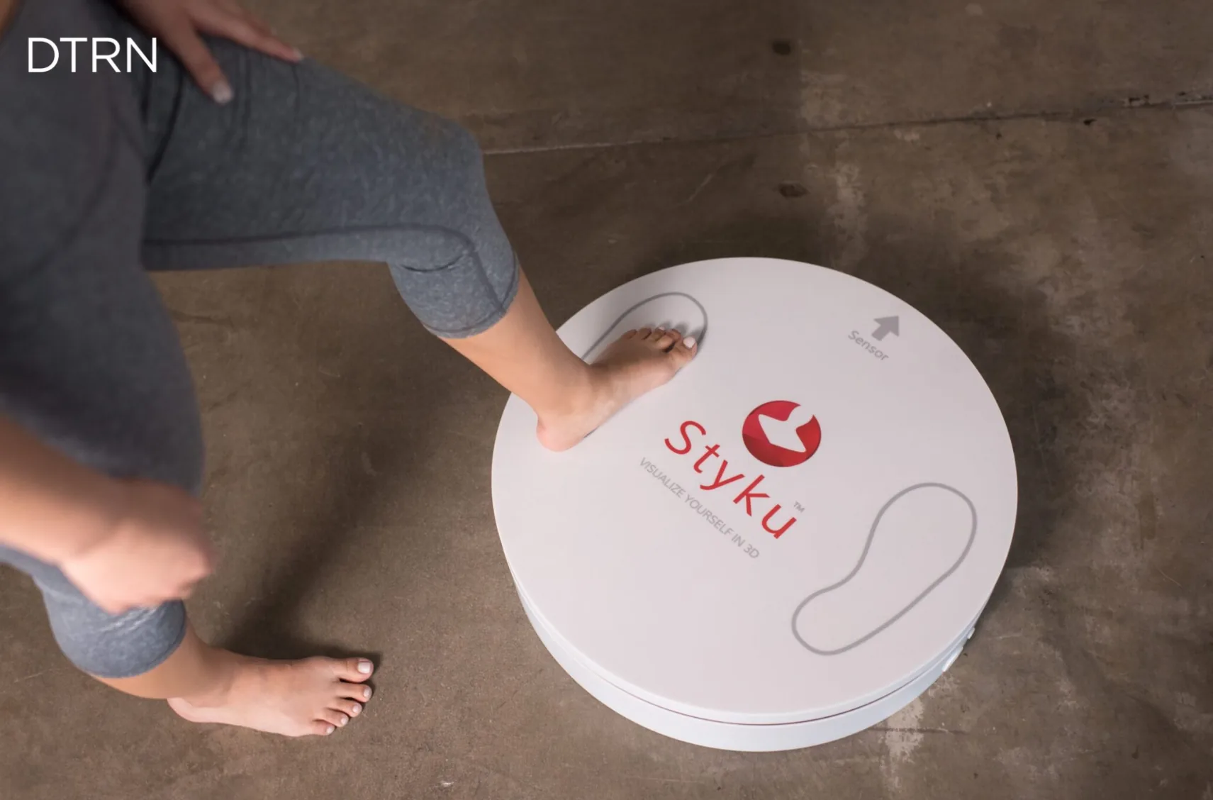 A patient stepping onto the Styku 3D body scanner platform